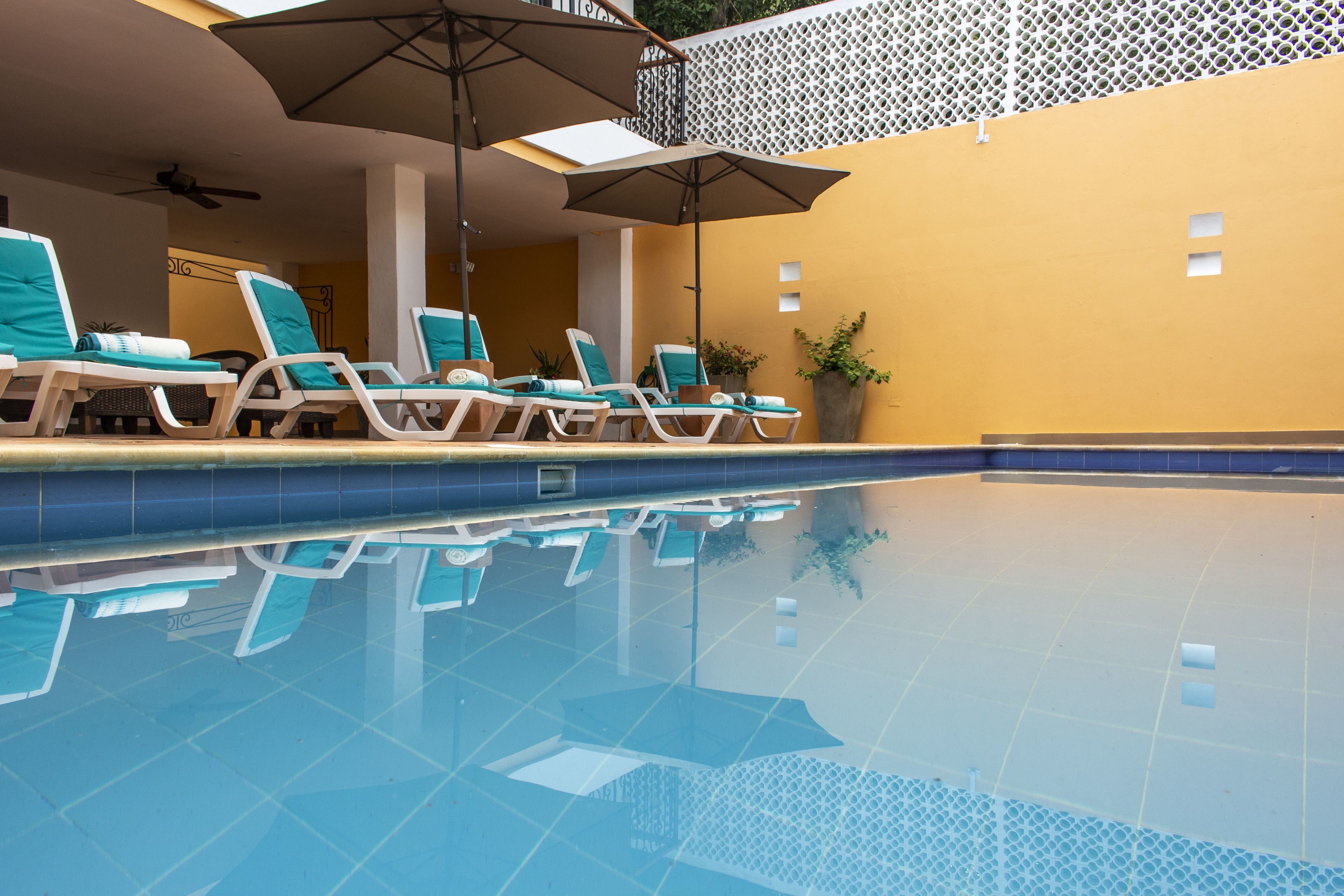 outdoor pool, open 9:00 am to 9:00 pm, pool umbrellas, pool loungers