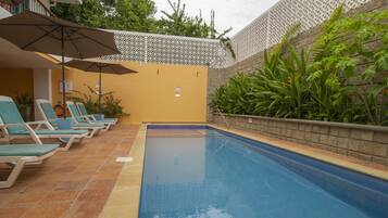 Outdoor pool, open 9:00 AM to 9:00 PM, pool umbrellas, pool loungers