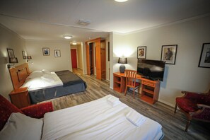 A hotel room with two beds, a desk, a television, and a chair. - Vesterland Feriepark Apartments (Sogndal)