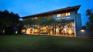 A modern two-story building with a flat roof and large windows. - Saffron and Blue by Jetwing (Kosgoda)