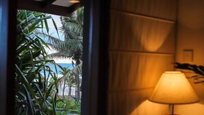 A room with a view of a beach, a lamp, and a bed. - Saffron and Blue by Jetwing (Kosgoda)