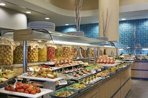 A buffet with various food options including fruits, vegetables, and prepared dishes. - Xanadu Island (Bodrum)