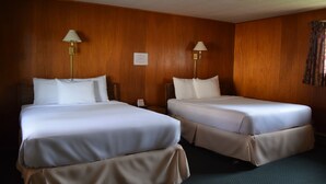 A hotel room with two beds, wooden paneling, and two bedside lamps. - Mid-City Motel (Sault Ste. Marie)