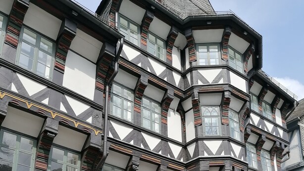 A traditional half-timbered building with a prominent corner entrance, a visible bar sign, and a large wooden door. - Pure resin romance; Time out for 2 persons; feel good and relax (Altenau)