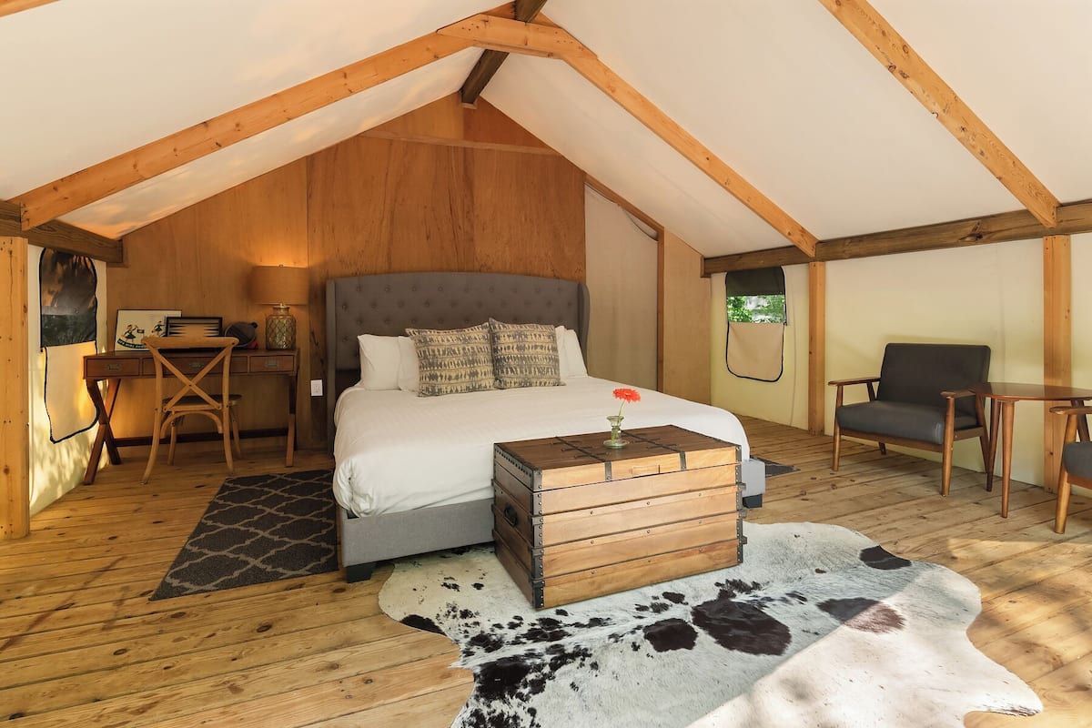 Un dormitorio acogedor con una cama, un escritorio y una silla.