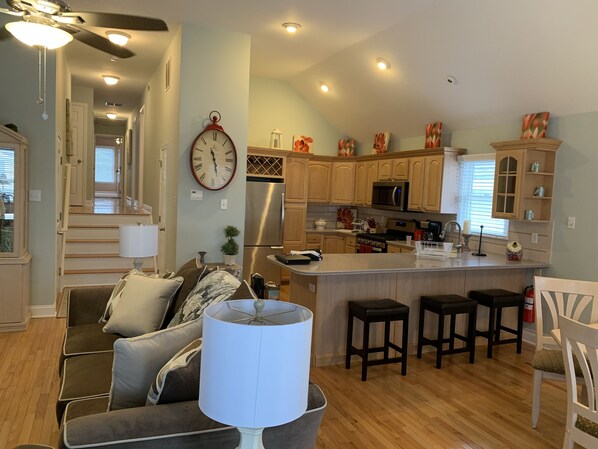 Relax in this open living space with a comfortable sofa and modern kitchen.