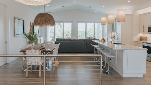A modern kitchen with a central island, bar stools, and pendant lighting. - Modern Island Luxury | 4 En-Suite Masters, 6 BA, Pool, Dock & Outdoor Oasis (Key Colony Beach)