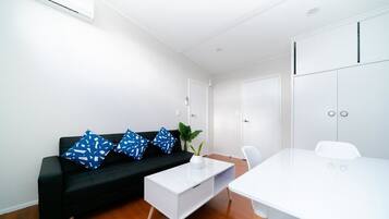 Family Suite - 1 Bedroom | Living area | Flat-screen TV