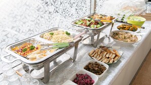 Una mesa de buffet con diversos platos y utensilios.