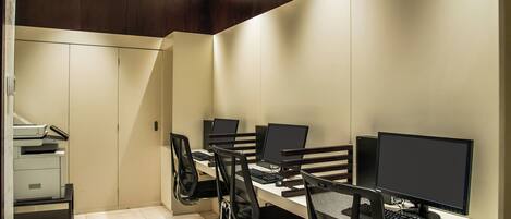 A modern office space with multiple desks, chairs, and computers.