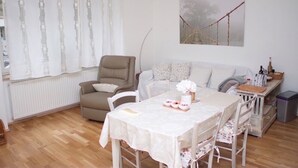 A cozy living room with a dining table, chairs, a sofa, and a painting on the wall. - Apartment in town centre,beautiful and quiet,ideal for families and couples (Zagreb)