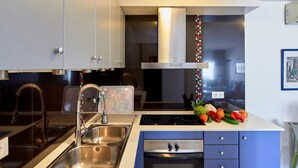 A modern kitchen with stainless steel appliances, a double sink, and a built-in oven. - APARTMENT 7 ADULTS POOL VIEW (L'Estartit)