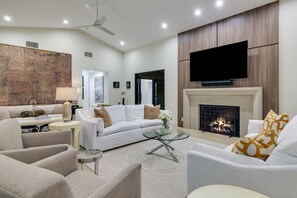 Smart TV, caminetto, libri, impianto stereo