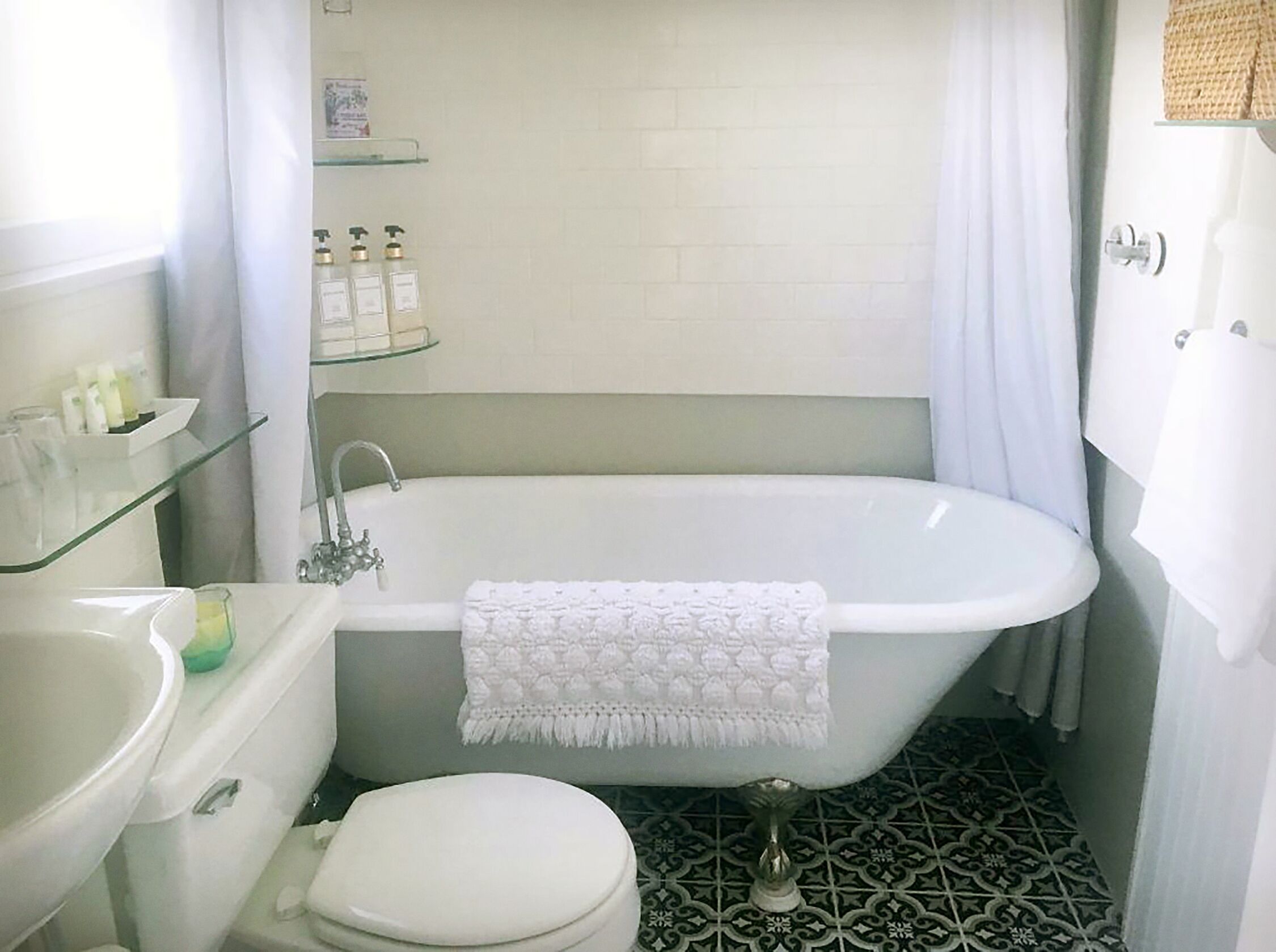 A bathroom with a freestanding bathtub, a toilet, and a sink.