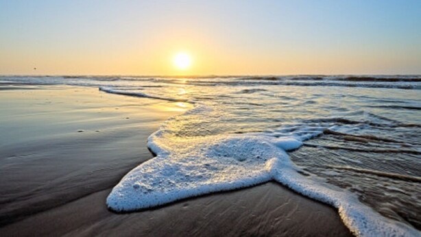 A beach with a sunset, waves, and a sandy shore. - NEW LISTING Day Break at SeaScape #2219: A Place to Rest, Relax, and Rejuvenate! (Galveston)