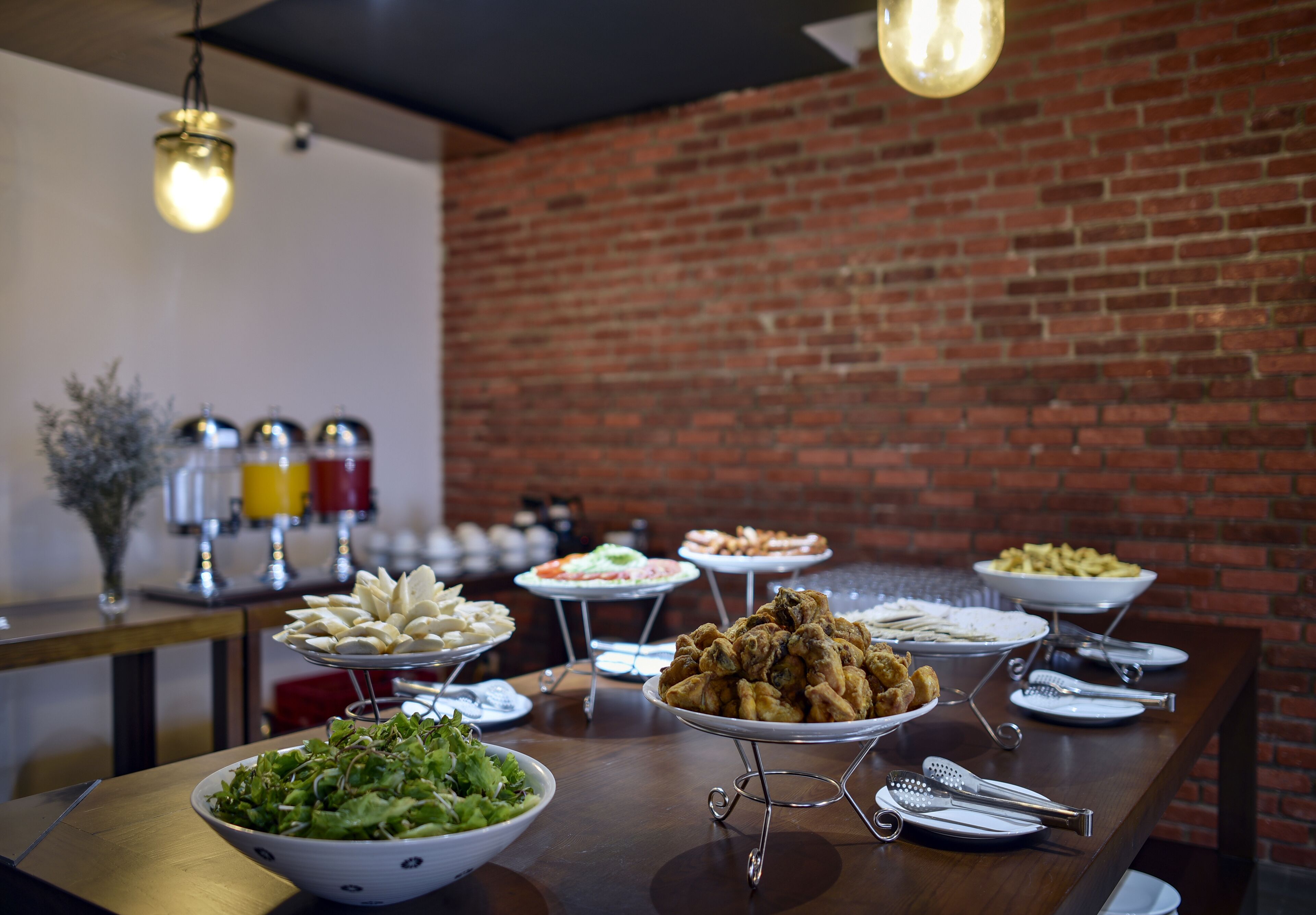 A buffet table with various dishes and utensils.