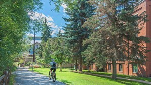 A pathway lined with trees and a building with a brick facade. - 224-A Studio/Main St/Town Lift/Pool/Hot Tub/Parking  (Park City)