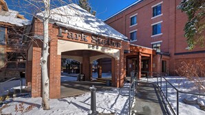 A brick building with a sign reading "Park Station 950" and a covered entrance with a metal railing. - 224-A Studio/Main St/Town Lift/Pool/Hot Tub/Parking  (Park City)