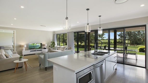 A modern kitchen with a central island, a dining area with a view of the outdoors, and a living room with a television. - 1OAK - THE VINTAGE HOLIDAY HOUSES (POKOLBIN)