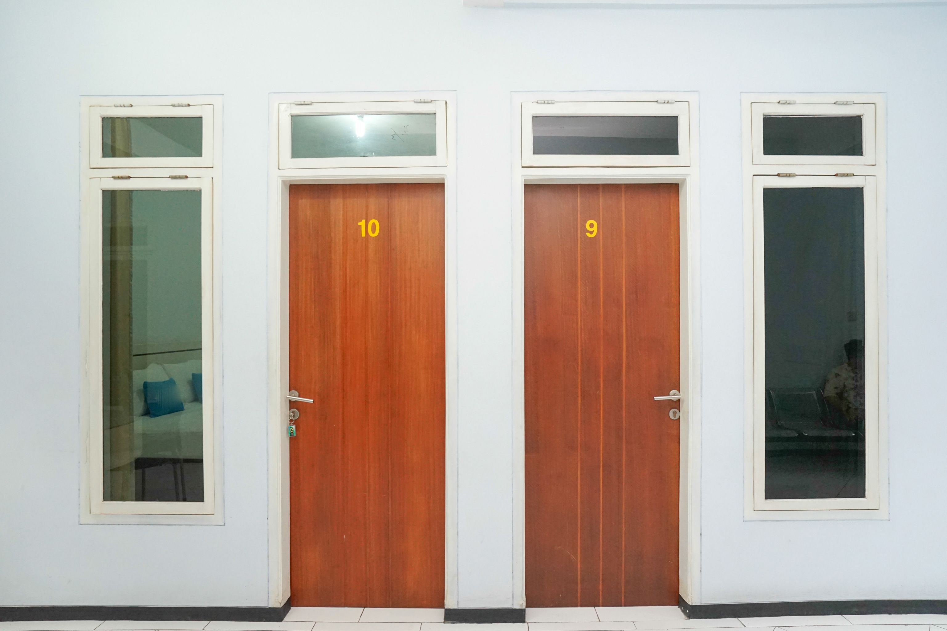 Four doors with numbers 9 and 10, each with a window above.