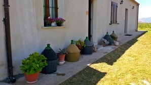 Un bâtiment doté d’un long et étroit porche bordé de plantes en pot.