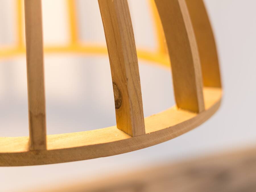 A close-up of a wooden chair with a circular backrest.