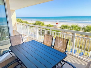 A balcony with a table and chairs overlooking a beach. - Crescent Shores S 210 (North Myrtle Beach)