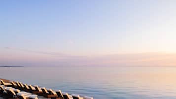 On the beach, sun loungers, beach umbrellas, beach towels