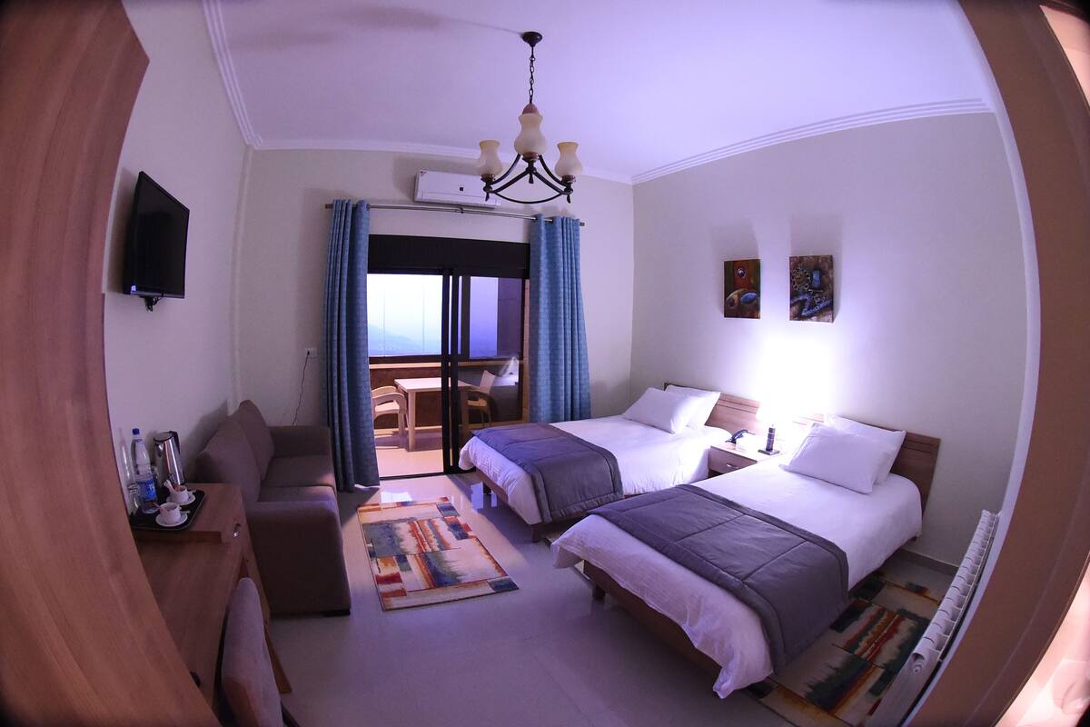 Twin Room (Coast View) | Minibar, in-room safe, desk, iron/ironing board