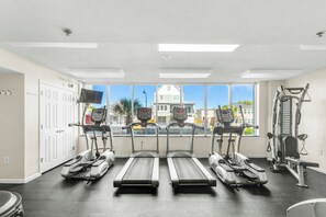 A gym with treadmills, a stationary bike, and weight machines.