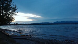 A row of boats parked by the lakeshore at dusk. -  TWO-ROOM APARTMENT SURROUNDED BY GREEN IN A QUIET RESIDENCE WITH POOL (Sirmione)