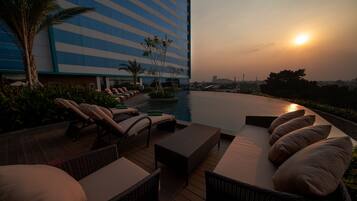 Outdoor pool, open 6:00 AM to 7:00 PM, pool loungers