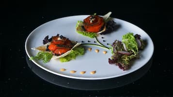A white plate with three different food items, each with a unique presentation.