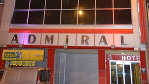 A hotel named ADMIRAL with a large grid of windows and a closed shutter door. - Admiral Hotel (Kocasinan)