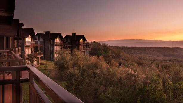 A resort with multiple buildings, balconies, and a view of the surrounding landscape. - Marula House (Naivasha)