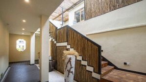 Un intérieur moderne avec un escalier, des murs en bois et un vase décoratif.