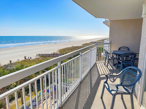 A balcony with a view of the beach, outdoor furniture, and a railing. - Crescent Shores S 311 (North Myrtle Beach)