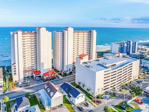 A coastal hotel with multiple high-rise buildings, a parking garage, and a view of the ocean. - Crescent Shores S 311 (North Myrtle Beach)