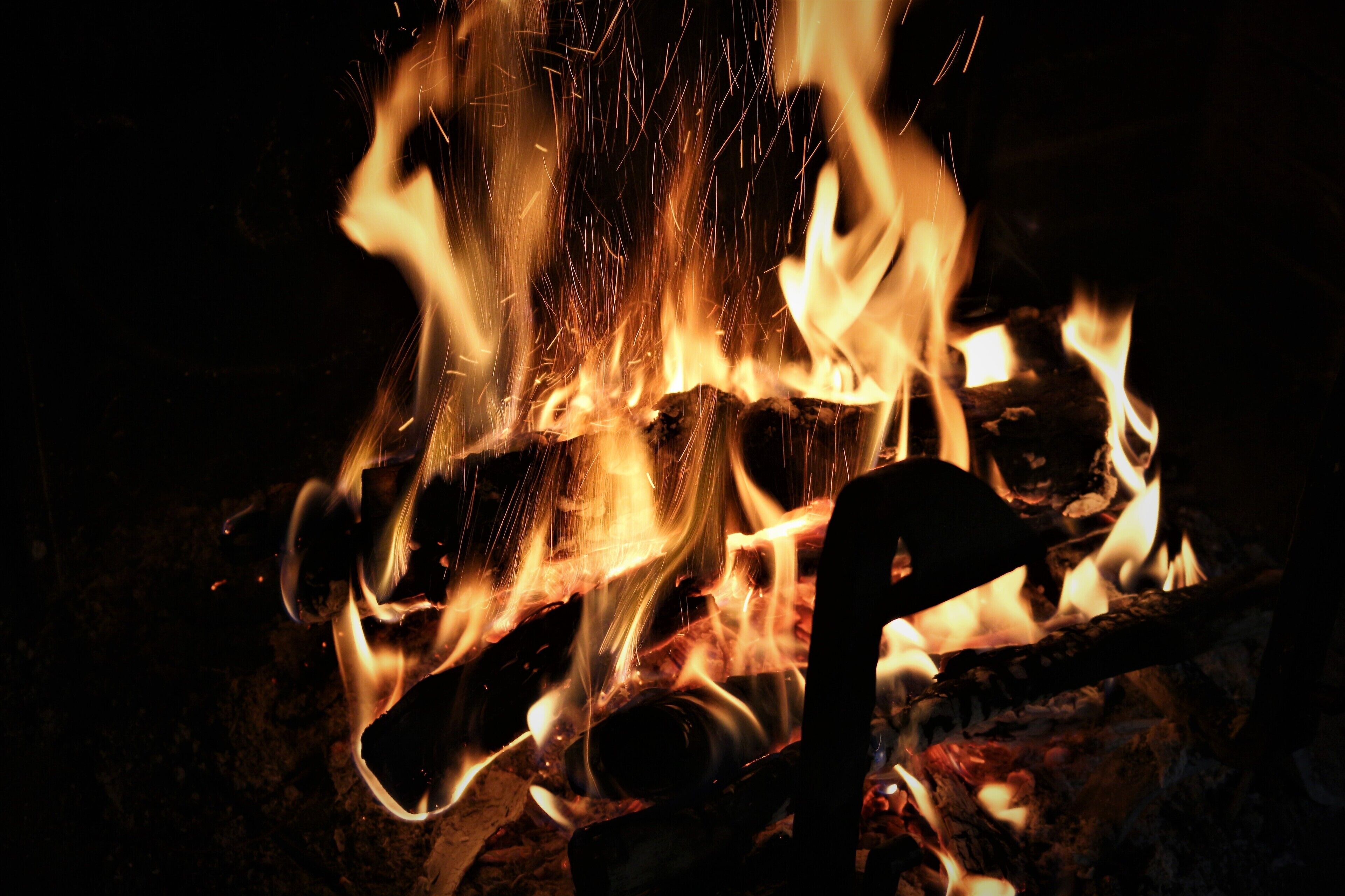 A close-up of a fire with visible flames and sparks.