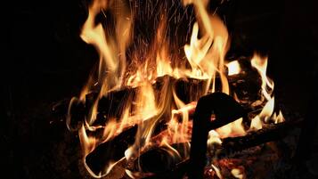 A close-up of a fire with visible flames and sparks.