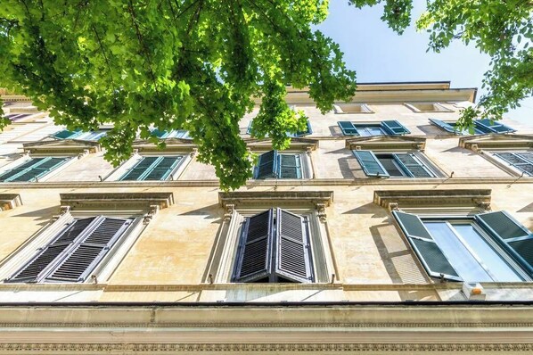 Stunning classical building with symmetrical facade and charming shutters.