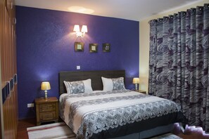 A bedroom with a bed, nightstands, and wall-mounted lamps. - Exquisite Serviced Apartment (Nairobi)