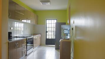 Apartment, Multiple Beds | Private kitchen | Full-sized fridge, microwave, oven, stovetop