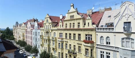A row of historic buildings with ornate facades and red-tiled roofs.