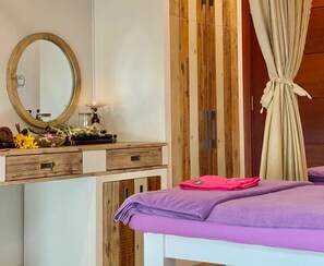 A bedroom with a wooden wardrobe, a mirror, a bed with a purple blanket, and a curtain tied at the top. - Sabina Hotel 2 (Ho Chi Minh City)