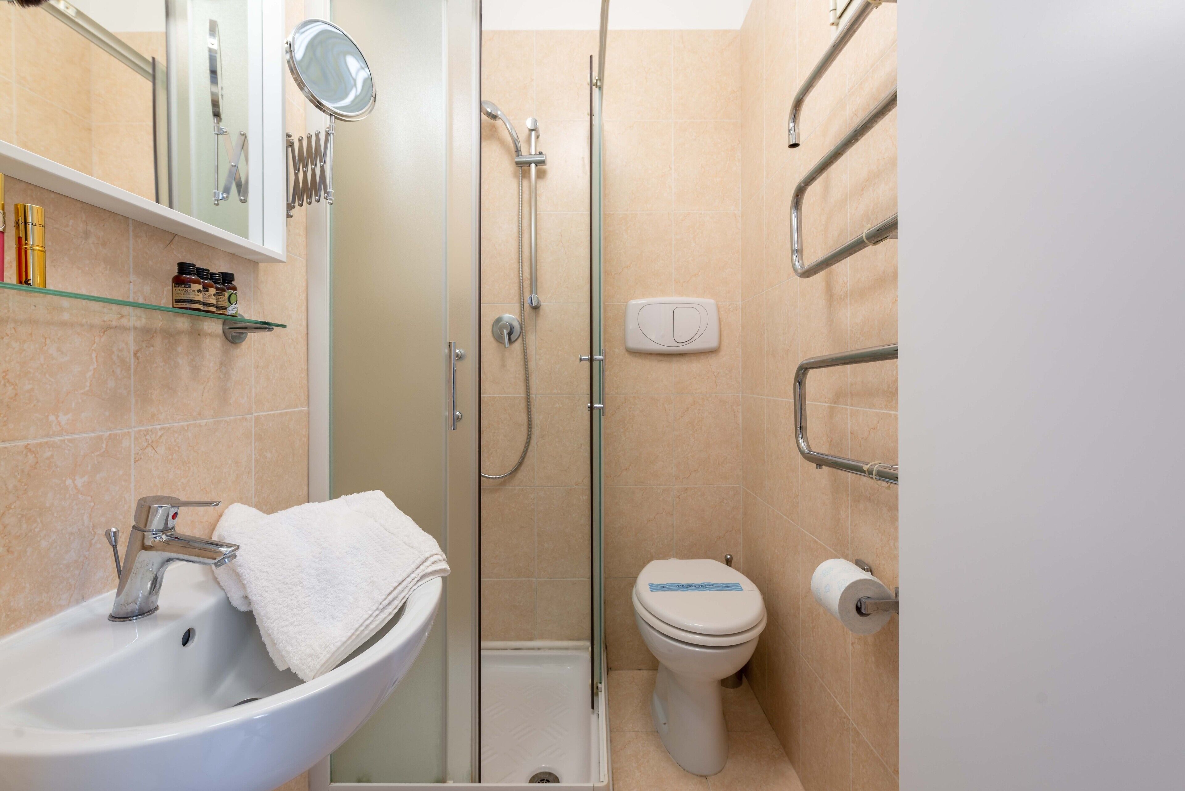 A bathroom with a sink, toilet, and shower.