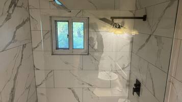 Combined shower/bathtub, towels, soap, toilet paper