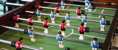A foosball table with players in red and blue uniforms.