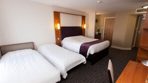 A hotel room with two beds, a wooden headboard, a desk, and a chair. - Premier Inn Leicester Fosse Park (Leicester)