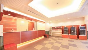 A reception area with a check-in counter, a small seating area, and self-service kiosks. - Richmond Hotel Hamamatsu (Hamamatsu)